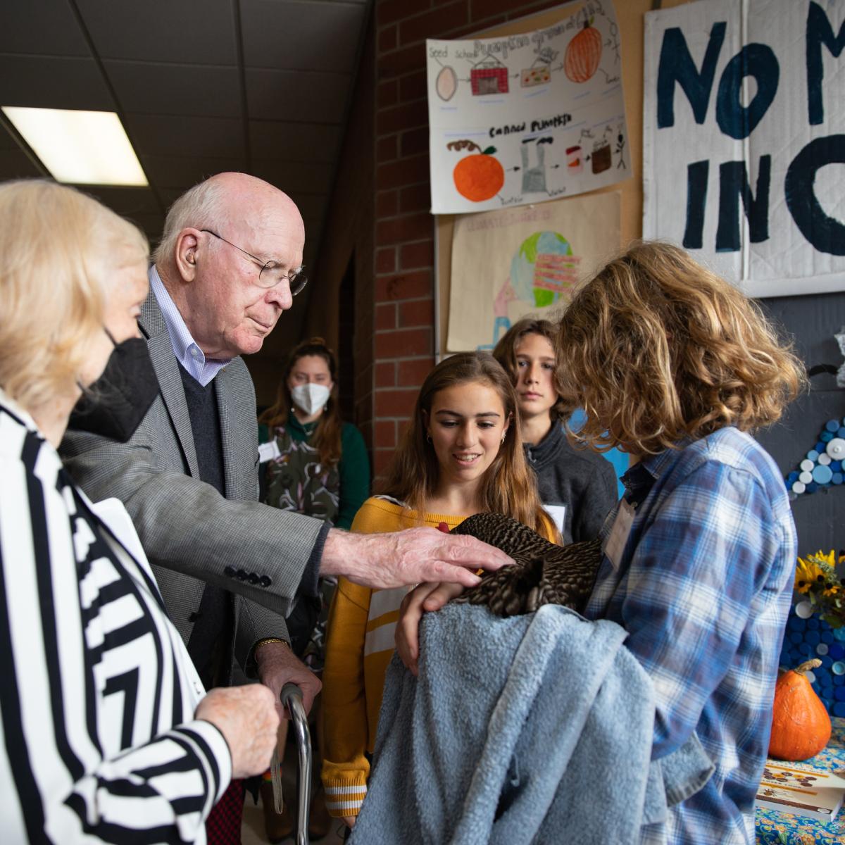 Senator Patrick Leahy and Marcelle Pomerleau talk with Crossett Brook Middle School students during the Farm to School Project Share.