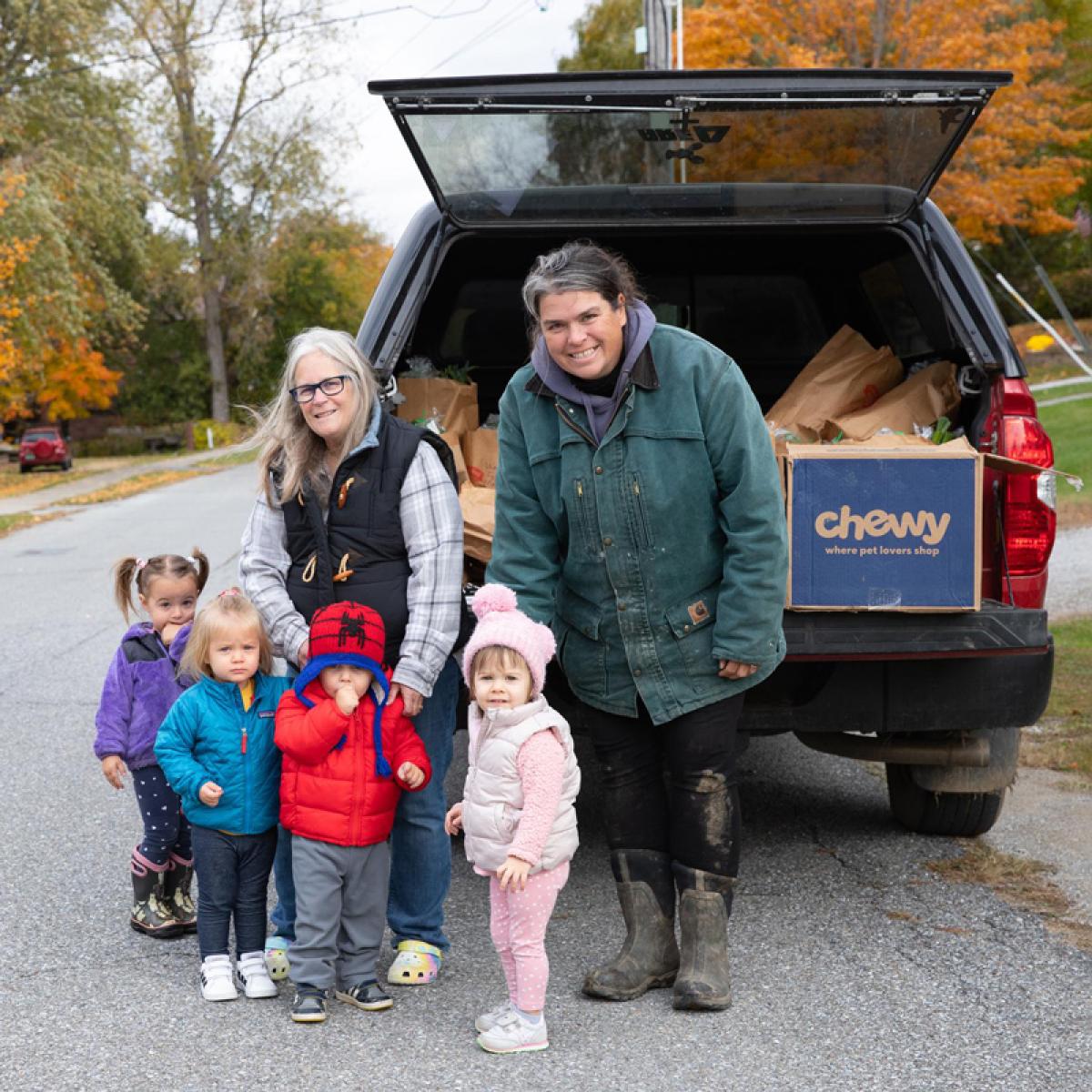 Laura Butler, the kids she cares for and teaches at her home-based childcare program, and farmer Christine Bourque of Blue Heron Farm on CSA drop-off day.