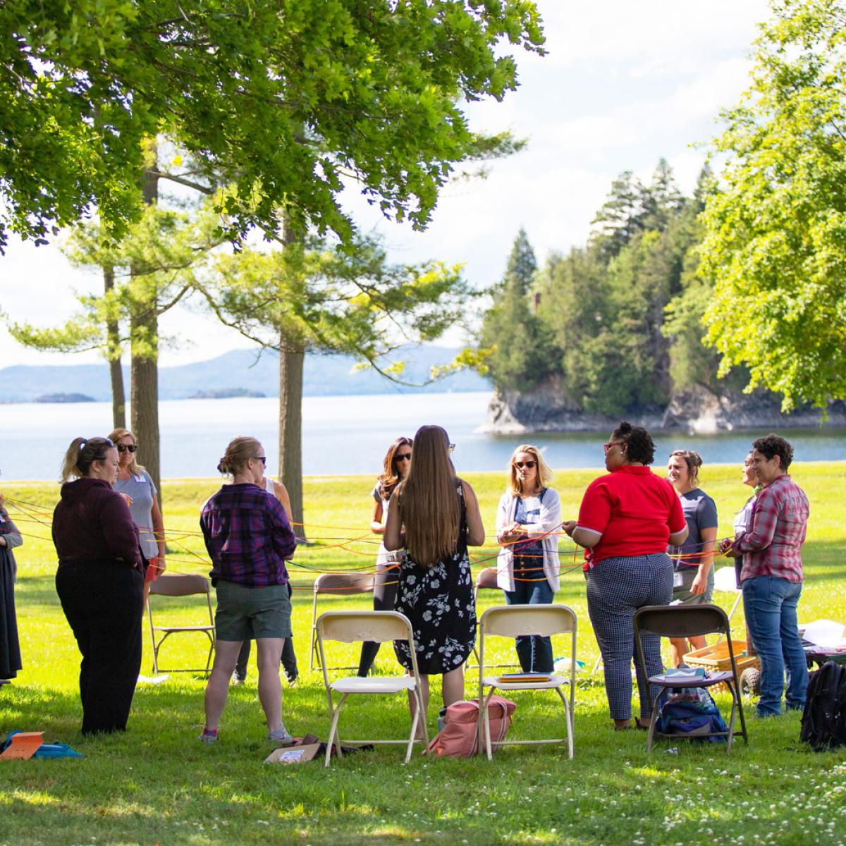 Educators gather outdoors at a recent Northeast Farm to School Institute summer retreat, learning together on the shores of Lake Champlain.