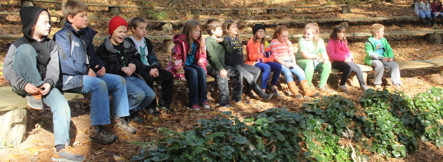 Sharon Elementary students gather in an outdoor classroom.